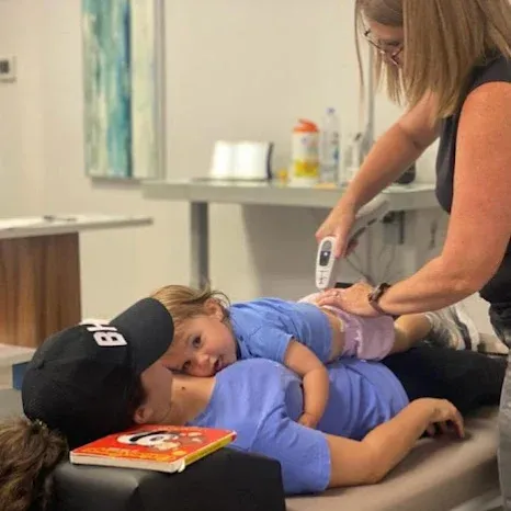 Chiropractor in Mountain Brook, AL, Performing a Chiropractic Adjustment on a Child.